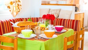 A dining area with a table set for breakfast, including bowls, glasses, and a fruit basket. - Villa Mellow - Three Bedroom Villa, Sleeps 6 (Ionian Islands)