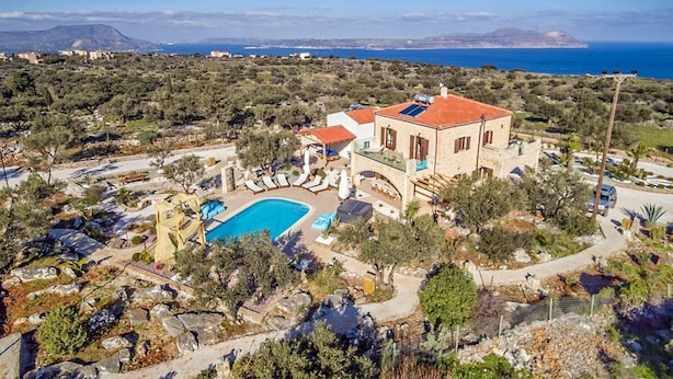 A Mediterranean-style villa with a swimming pool, surrounded by olive trees and a view of the sea. - Villa Peristeri - Six Bedroom Villa, Sleeps 18 (Apokoronos)