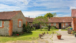 A courtyard with stone buildings, a paved walkway, and potted plants. - 2 bedroom accommodation in South Barrow, near Yeovil (South Barrow, near Yeovil)