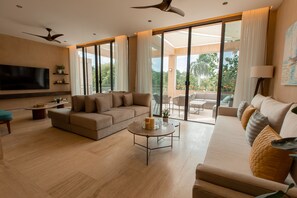 Deluxe Apartment, 2 Bedrooms | Living area | Smart TV, books - Lumina at The Village Luxury Residences in Corasol (Playa del Carmen)