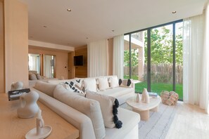 Premier Apartment | Living area | Smart TV, books - Lumina at The Village Luxury Residences in Corasol (Playa del Carmen)