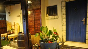 A hotel entrance with a blue door, a potted plant, and a tiled floor. - Ahuzat Shaul Hotel Seaside (Hadera)