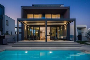 A modern two-story house with a covered outdoor area and a swimming pool. - Villa Acacia (Zadar)