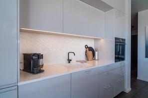 Prepare meals in the well-equipped kitchen with a coffee maker and ample counter space.