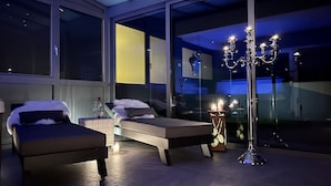 A modern bedroom with two beds, a large window, and a floor lamp. - Garden/whirlpool/combination sauna large kitchen, rain shower. Very modern (Habscheid)