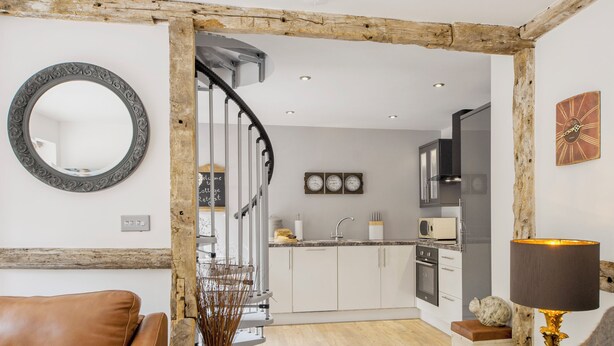 A modern kitchen with white cabinets, a built-in oven, and a microwave. - 1 bedroom accommodation in Harvington, near Evesham (Harvington, near Evesham)