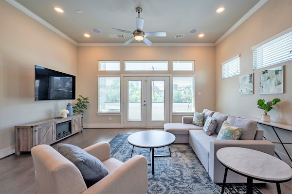 Spacious living room with a 65" HDTV equipped for streaming services.