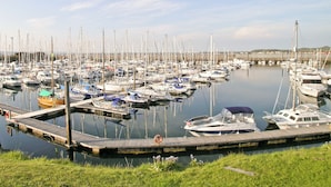 A marina with numerous boats docked at wooden piers. - 2 bedroom accommodation in Girvan (Girvan)