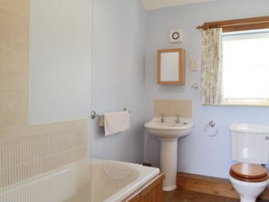 A bathroom with a bathtub, sink, toilet, and a shower.