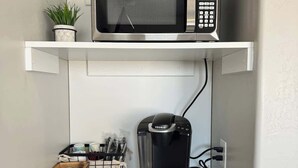 A compact kitchenette with a microwave, coffee maker, and a small refrigerator. - Kanab Retreat by National Parks, Quiet Suite #1 (Kanab)