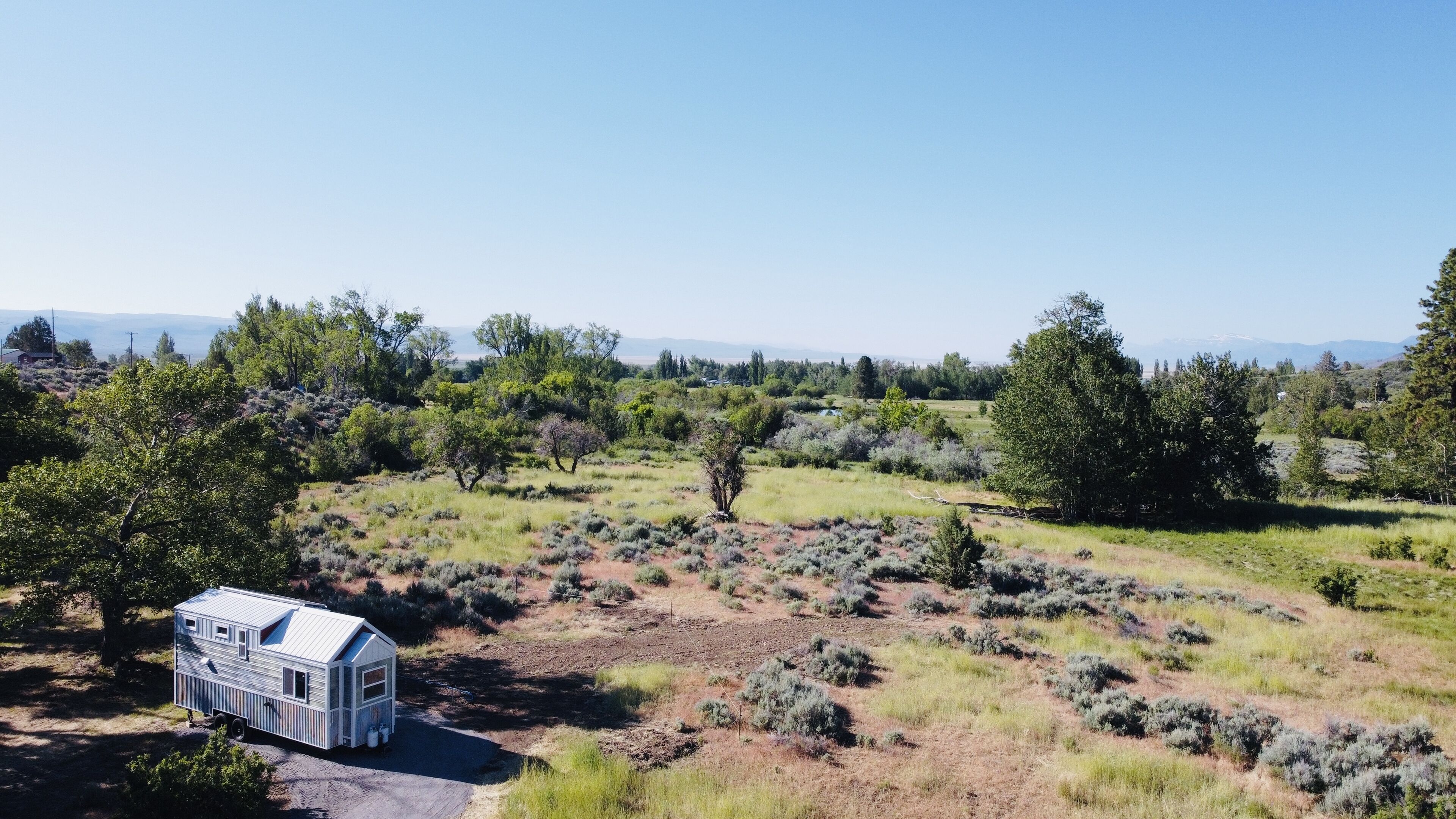 A mobile home in a rural setting with a clear view of the surrounding landscape.