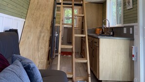 A kitchen with wooden cabinets, a built-in stove, and a window.