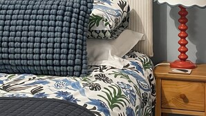 A neatly made bed with patterned bedding, a bedside lamp, and a wooden nightstand. - 2 bedroom accommodation in Brampton, near Carlisle (Brampton, near Carlisle)