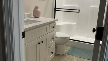 Shower, hair dryer, towels, toilet paper