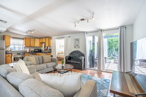 Relax in this spacious living area with a comfortable sofa, flat-screen TV, and fireplace.