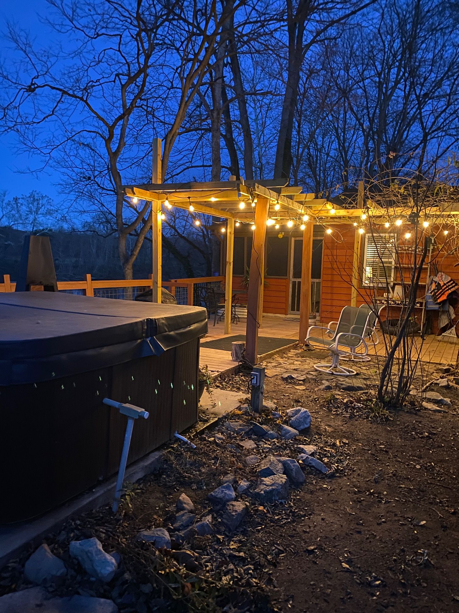 A hot tub and outdoor seating area with string lights.