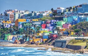 A coastal cityscape with colorful buildings.