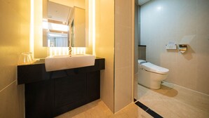 A modern bathroom with a black vanity, a white sink, and a toilet. - HOTEL CORE (Naju)