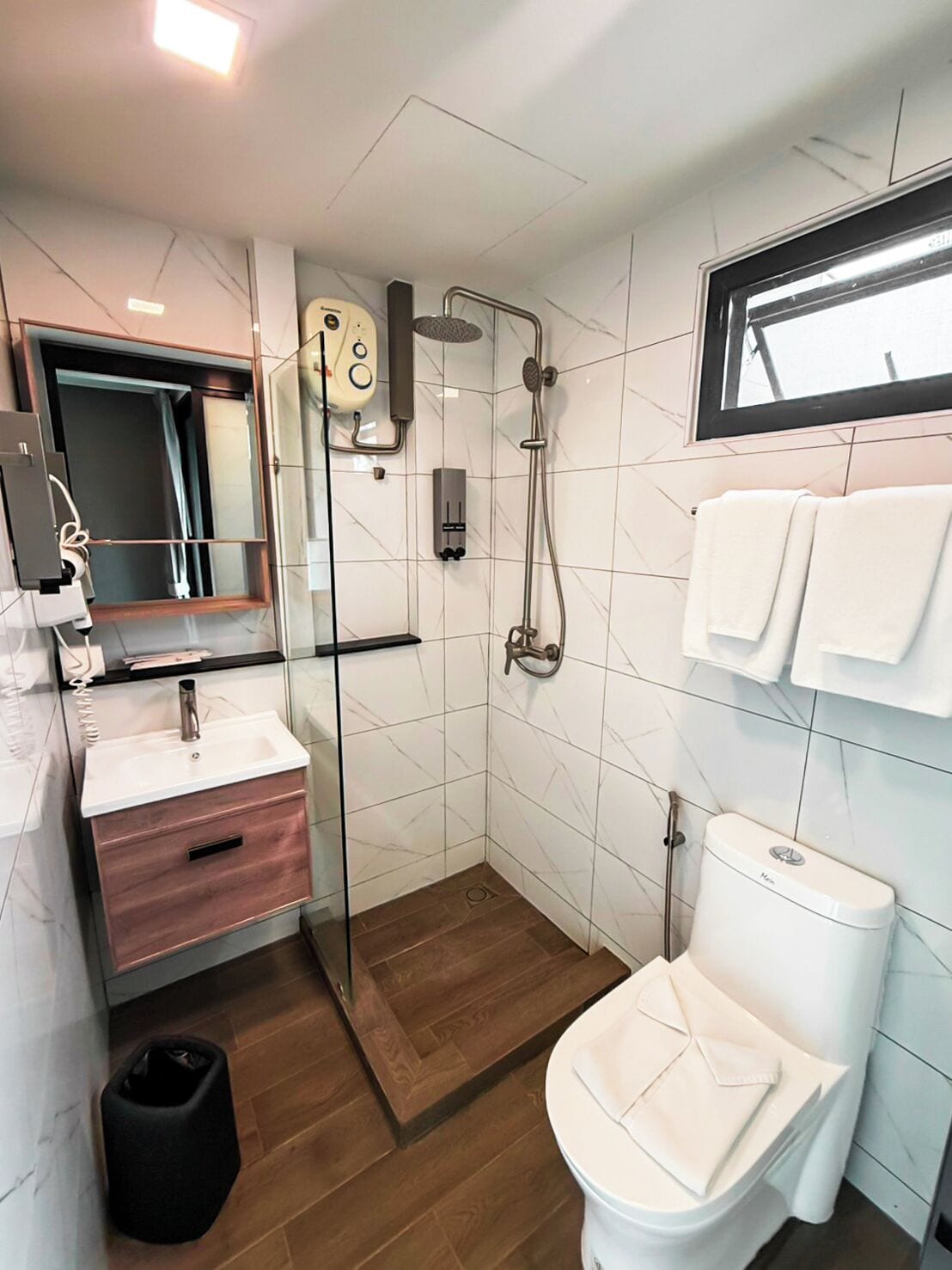 shower, rainfall showerhead, hair dryer, towels