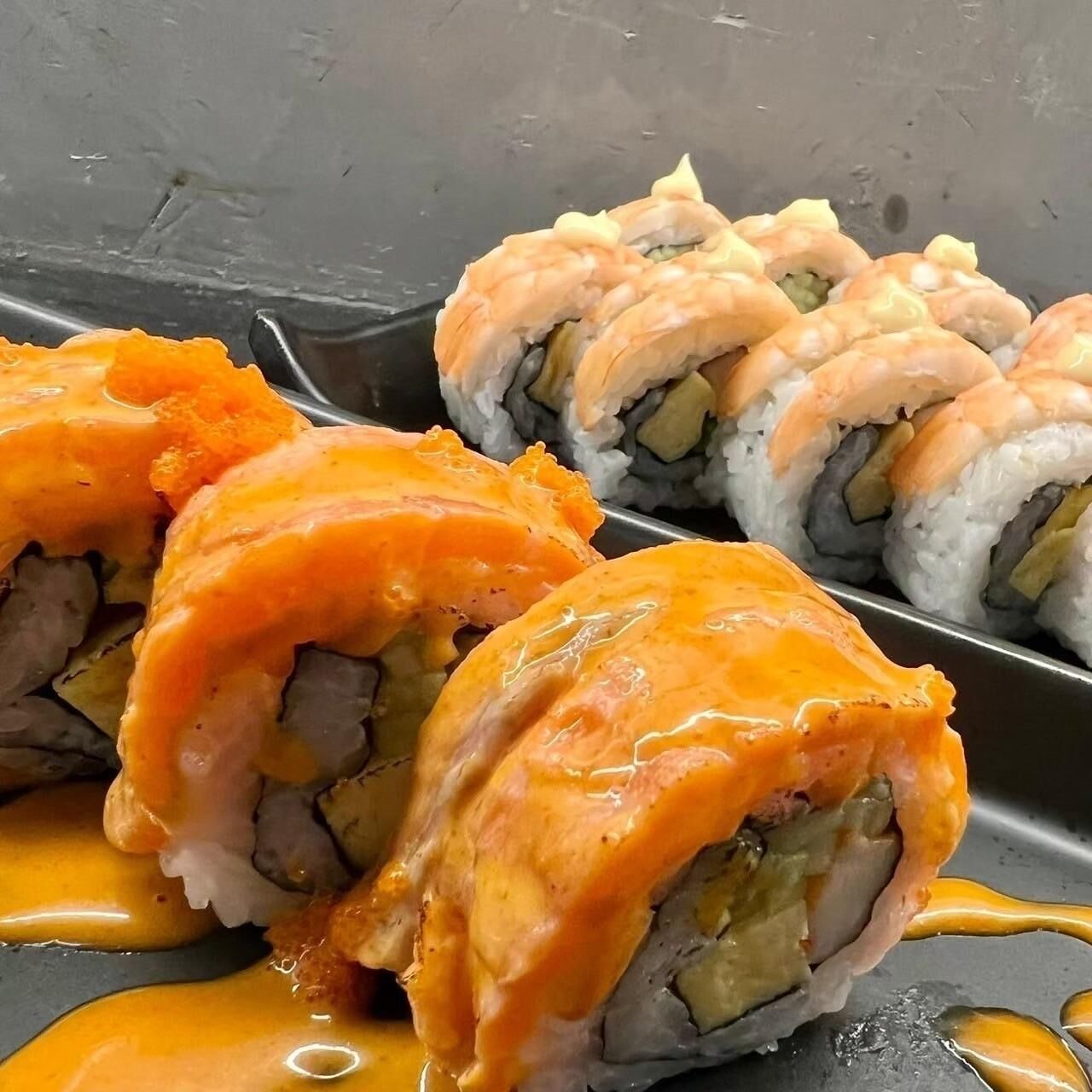 Sushi rolls with a creamy sauce.