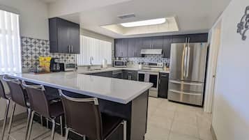 Full-sized fridge, coffee/tea maker, high chair, toaster oven