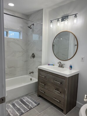 Combined shower/tub, hair dryer, towels, soap