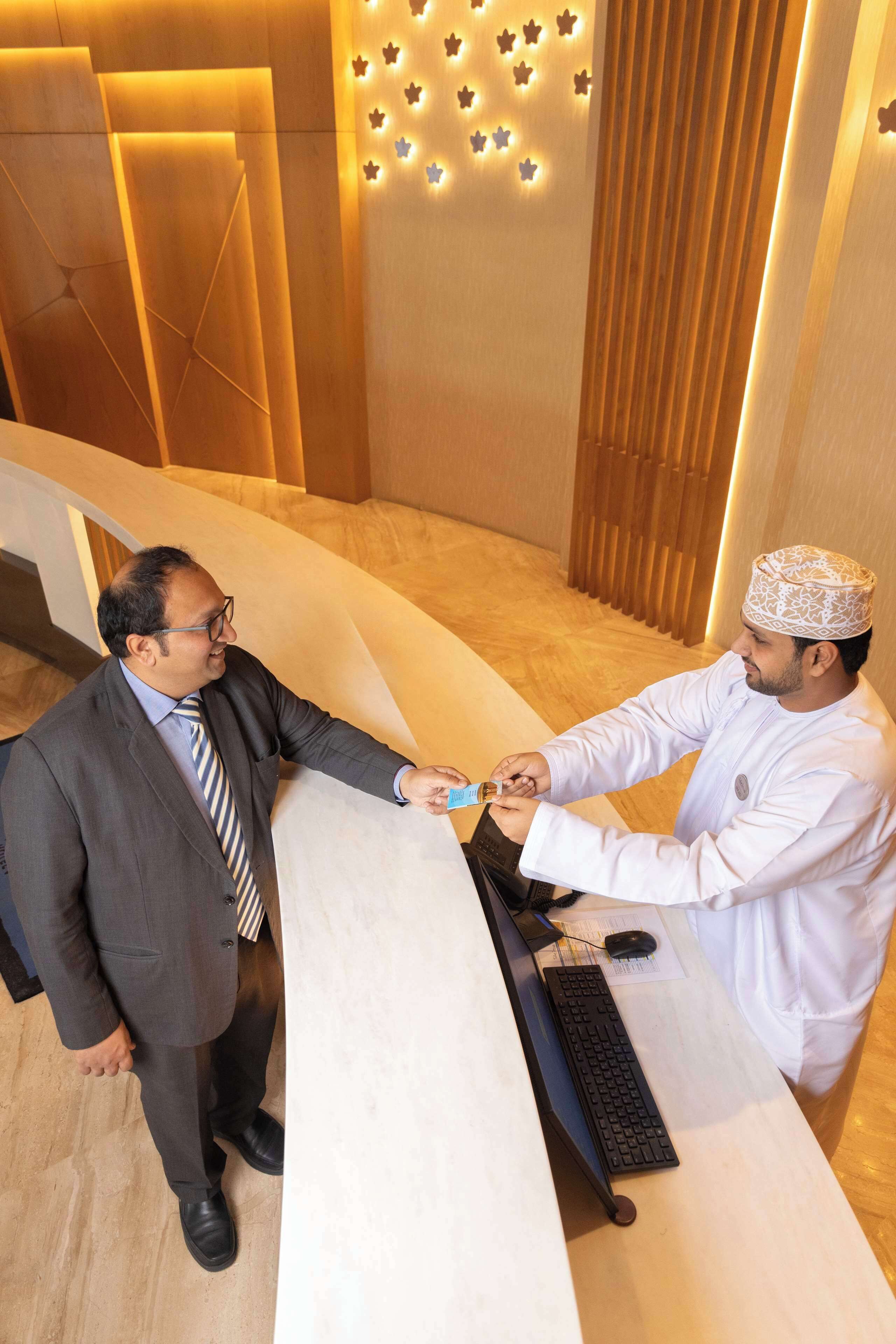 A reception desk with a modern design, a keyboard, and a mouse on it.