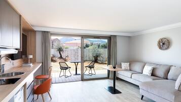 A modern apartment with a kitchen, dining area, and a sofa.