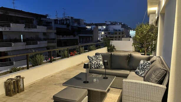 A rooftop terrace with a sofa set, a table, and potted plants. - Athens Neos Kosmos Penthouse, city center & sea view (Athina)