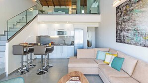 A modern interior with a kitchen, dining area, and living room.