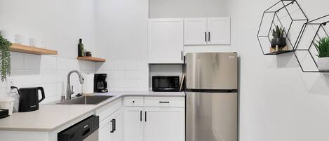 Fridge, microwave, coffee/tea maker, cookware/dishes/utensils