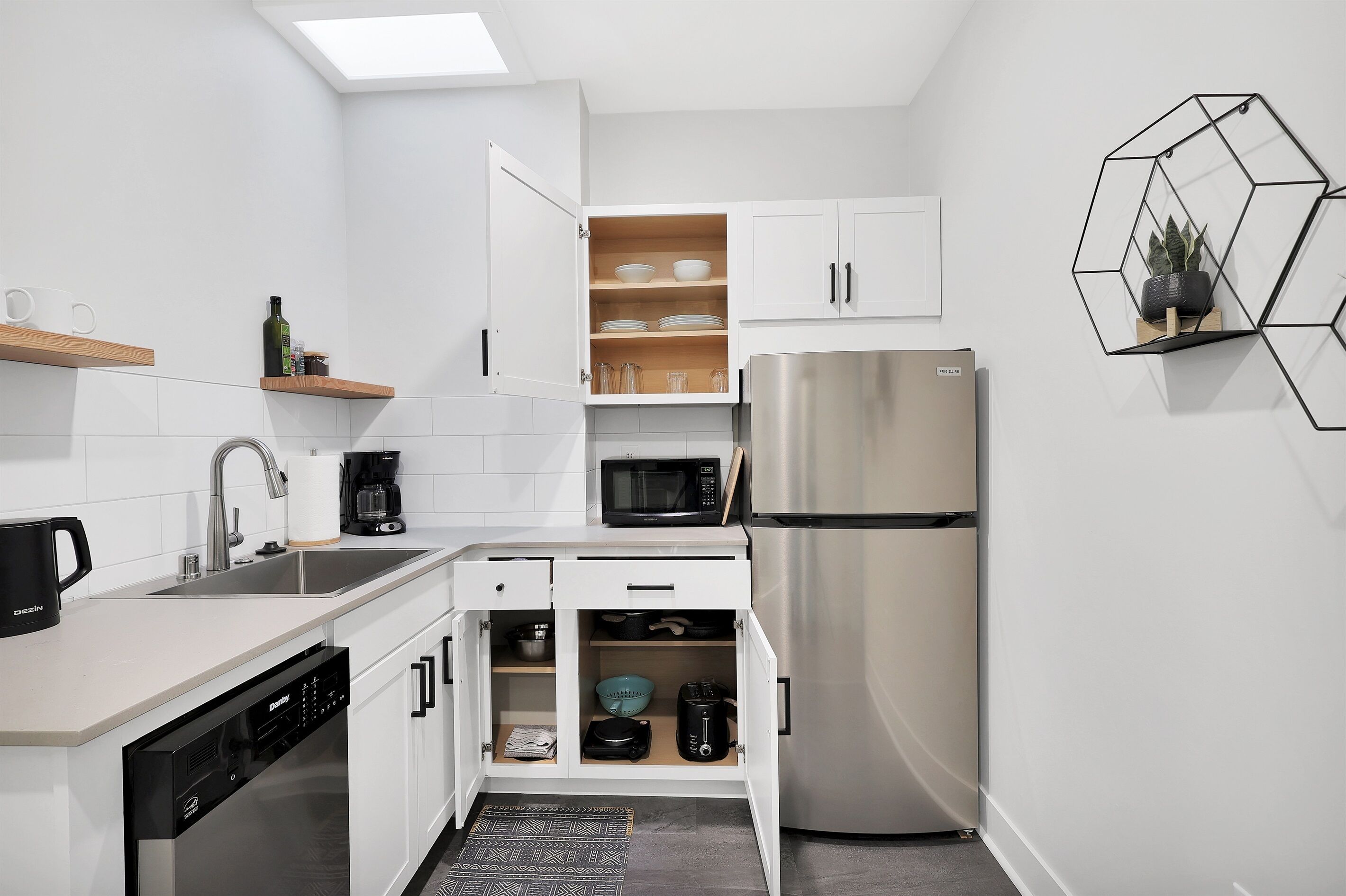 Fridge, microwave, coffee/tea maker, cookware/dishes/utensils