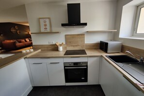 Enjoy cooking in this well-equipped kitchen with oven, dishwasher, and induction cooktop.