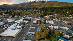 An aerial view of a town with a prominent mountain in the background.