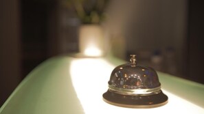 A bell on a counter with a blurred background. - Granda Hotel (Kashar)