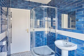 Bathtub, hair dryer, towels, toilet paper