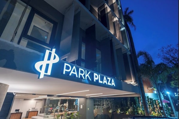 A building with a sign reading 'PARK PLAZA' and a modern architectural design.