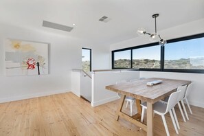 Enjoy meals at the dining table with a view of the outdoors.