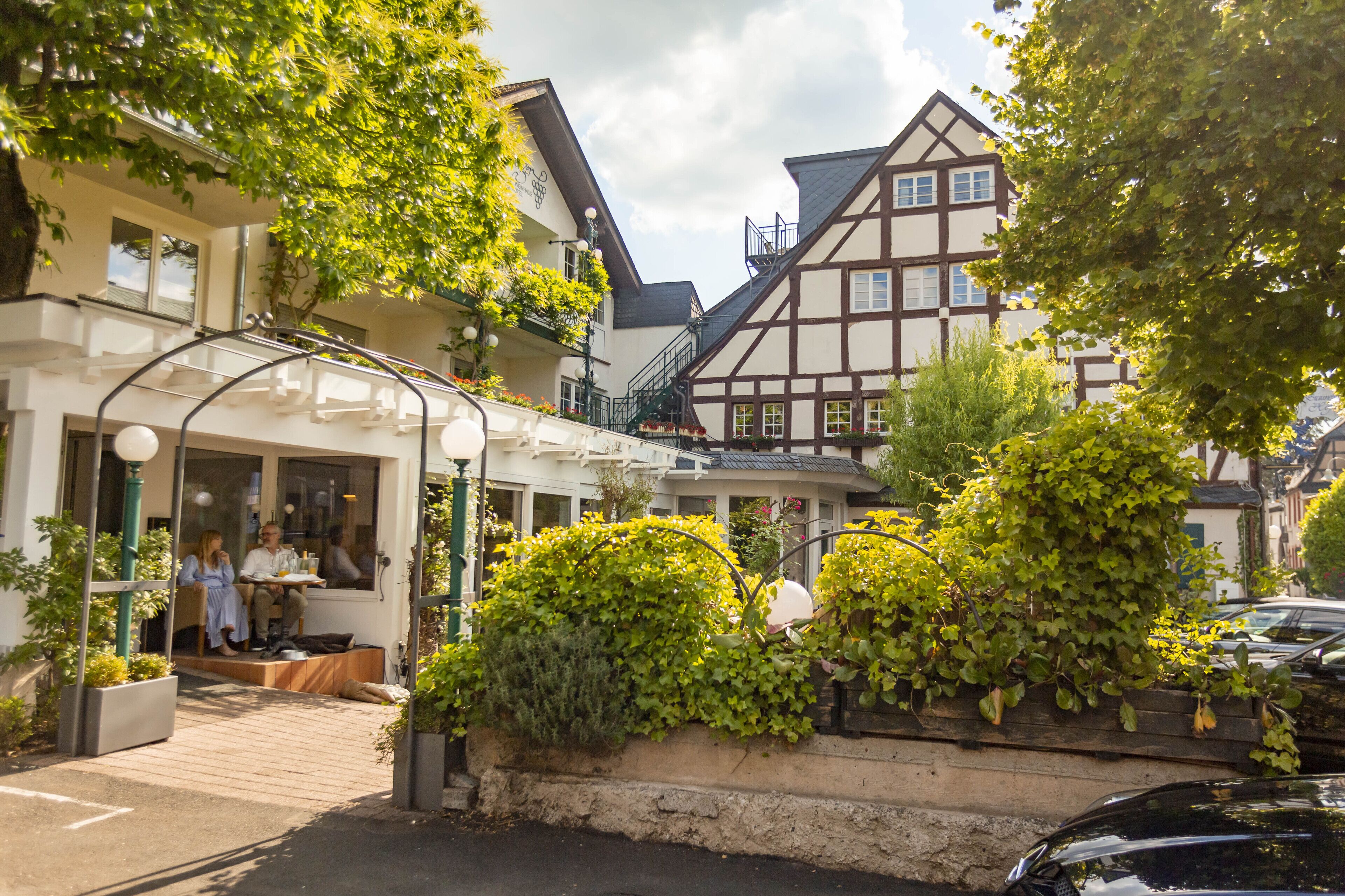 A traditional European building with a balcony and outdoor seating area.