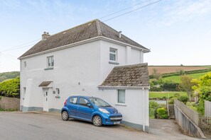 A two-story white house with a blue car parked in the driveway. - 4 Bed in Frogmore (oc-bc721) (Frogmore)