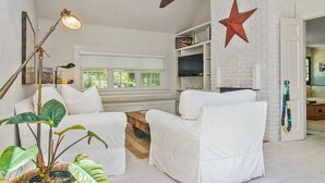 A white living room with a star decoration, a lamp, and a plant. - Classic Hamptons home in Springs.  Pool, lovely back yard and steps to the beach (East Hampton)