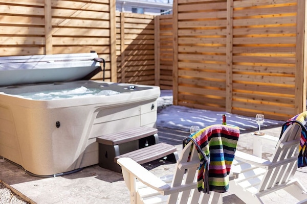 The large hot tub is further down the patio with its own privacy fencing.