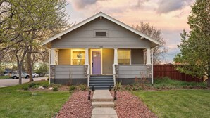 A single-story house with a front porch, a purple door, and a number '130' on the front.