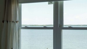 A bedroom with a large window overlooking a body of water. - Waterfront Tilghman Retreat with Dock, Fire Pit & Sunsets (Tilghman Island)