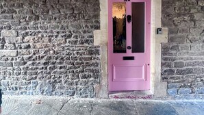 A pink door with the number 14A, set in a stone wall. - Merchants Town House - Catherine Hill (Frome)