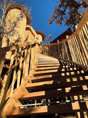 Staircase leads to a traditional building with a sloped roof.