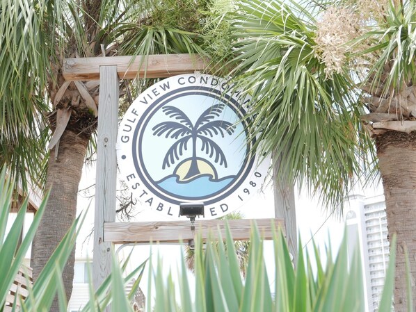 Enjoy ocean views from this condominium, surrounded by lush palm trees.