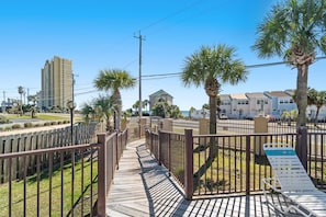 Guests can stroll along the boardwalk to a lounge area with a chair.