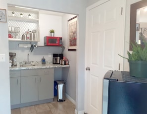 Fridge, microwave, coffee/tea maker, cookware/dishes/utensils