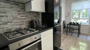 Apartment, 1 Queen Bed | Private kitchen | Fridge, microwave, oven, stovetop